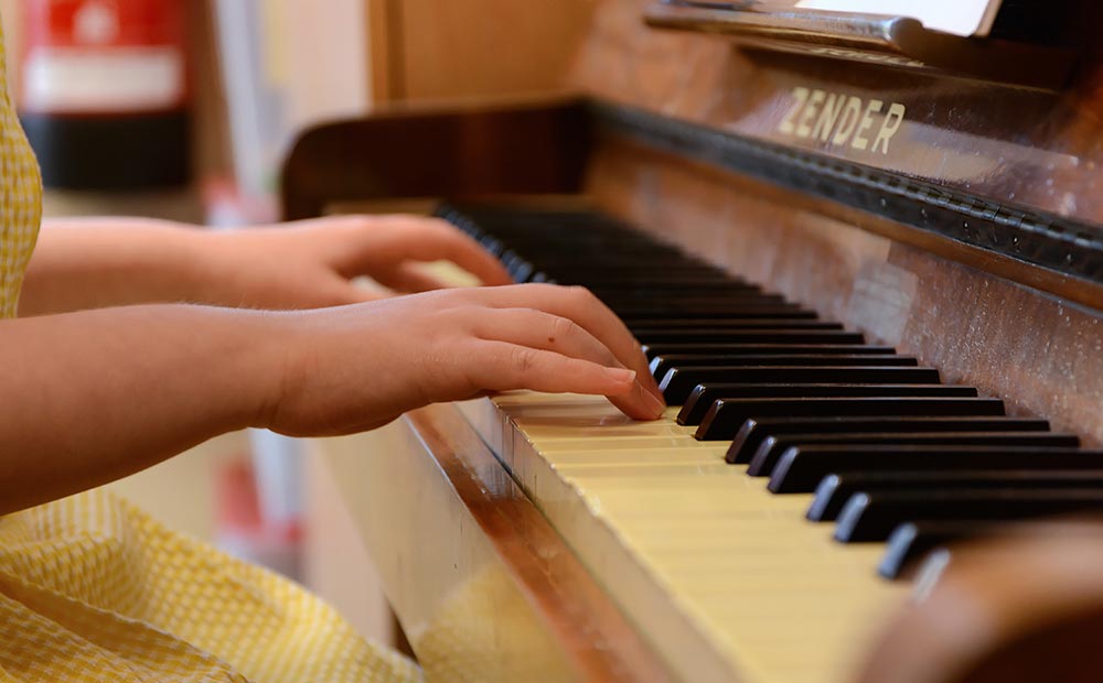 Hands Resting on Piano Keys