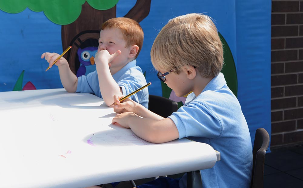 Two Boys Holding Pencils